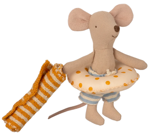 Stuffed toy mouse holding a striped blanket and polka dot towel on a white background