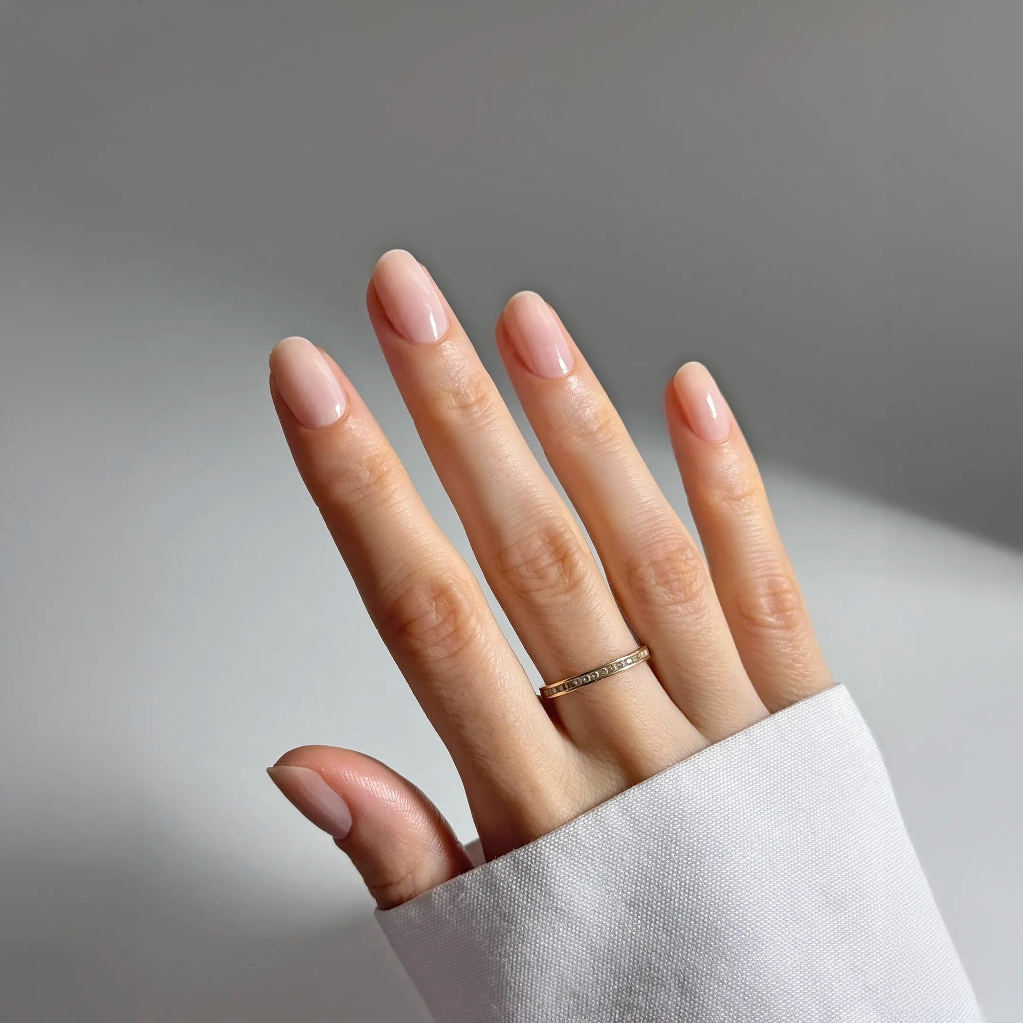 A bottle of Kure Bazaar nail hardener in beige color with a label that reads 'REHABILITATION THERAPY COMPLEX LE VEINS CONCEALER'.