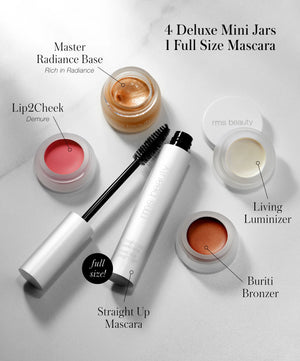 Collection of makeup products including mascara, lip gloss, and bronzers on a light background