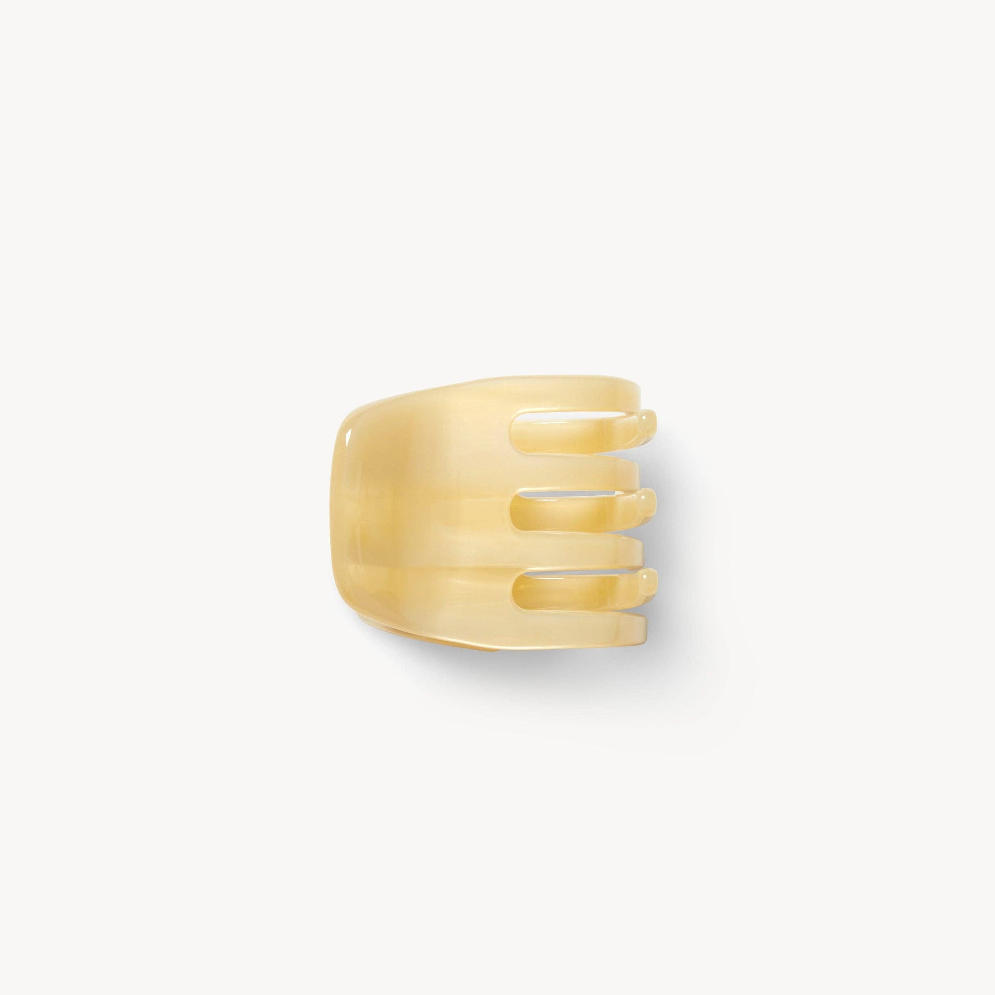Gold ring with a textured design on a white background