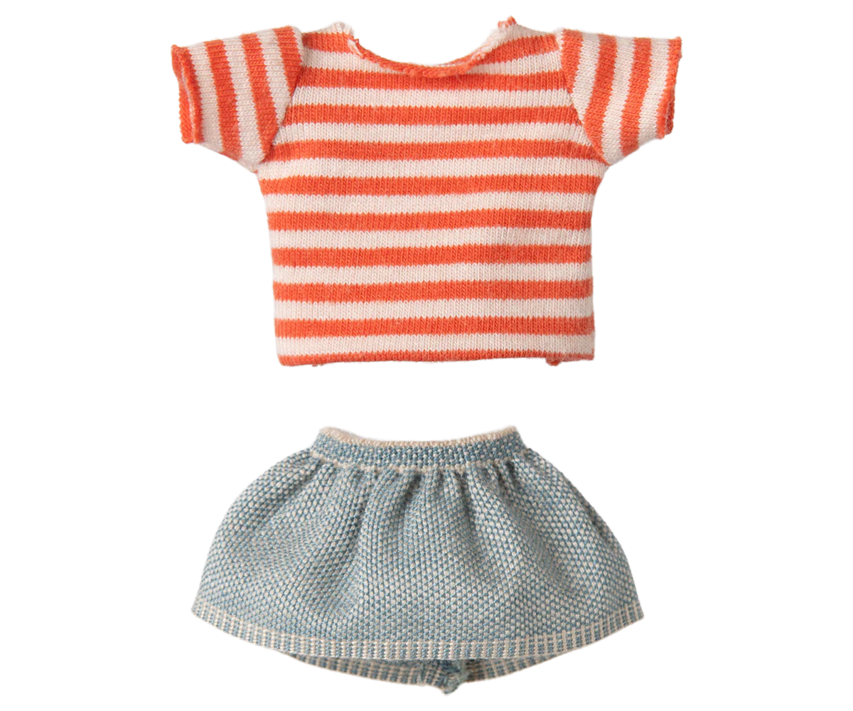 Striped shirt and checkered shorts on a white background