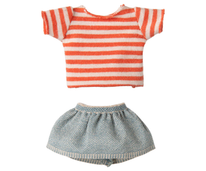 Striped shirt and checkered shorts on a white background