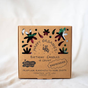A brown box of Happy Organics raspberry birthday candles