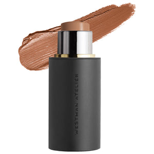 Black cosmetic stick with brown applicator and swatch on white background, featuring 'Westman Atelier' branding.