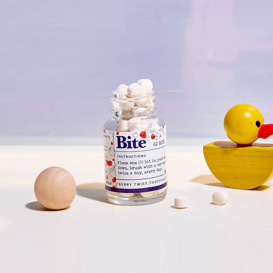A bottle of Bite toothpaste tablets, next to a yellow duck. 