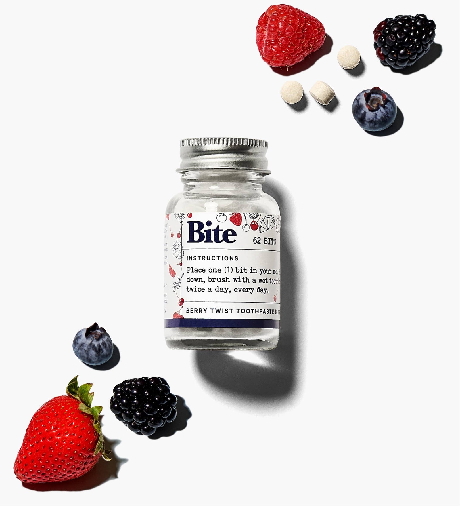 A bottle of bite berry toothpaste tablets, with fruit and berries. 