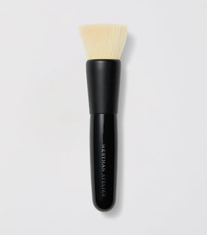 A black and white blender brush with a flat synthetic head and a black wooden handle.