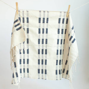 A blue and white tea towel with a clothespin.