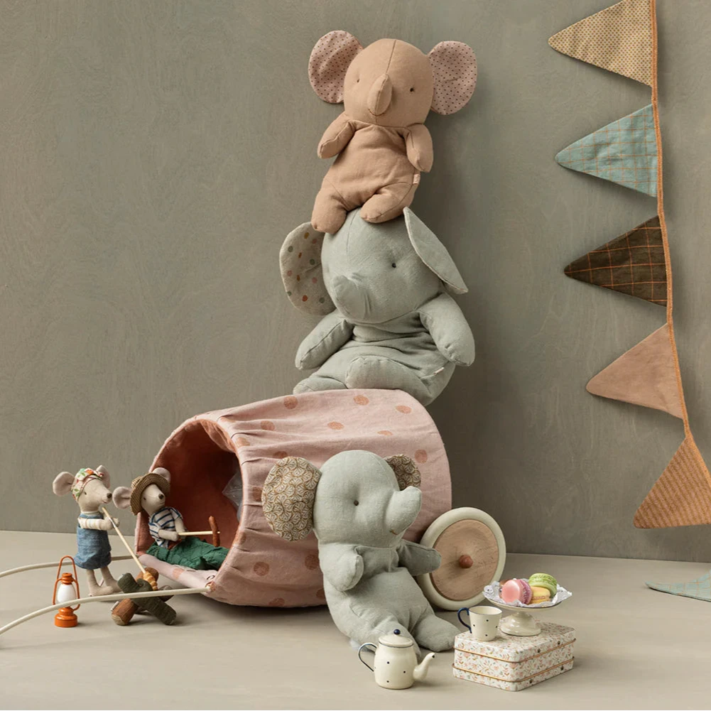 Children's toys and plushies on a neutral background