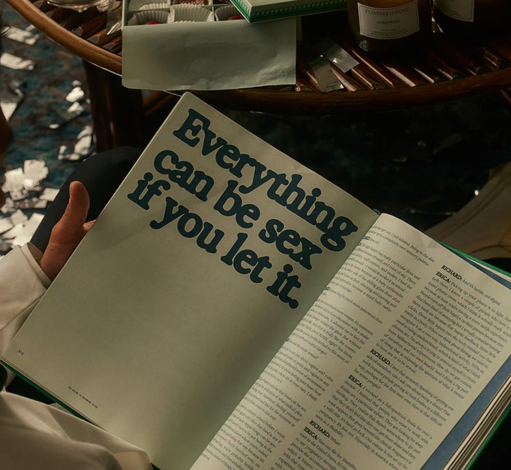 An open page of a book, with a table in the background. 