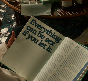 An open page of a book, with a table in the background. 