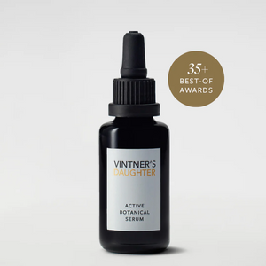 A black bottle with a dropper containing Active Botanical Serum, with a label that includes the brand name and product name. There is a badge indicating '35 BEST-OF AWARDS' on the upper right corner.
