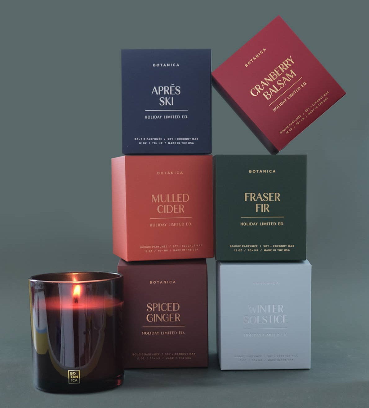 Collection of Botanica candles and boxes on a gray background