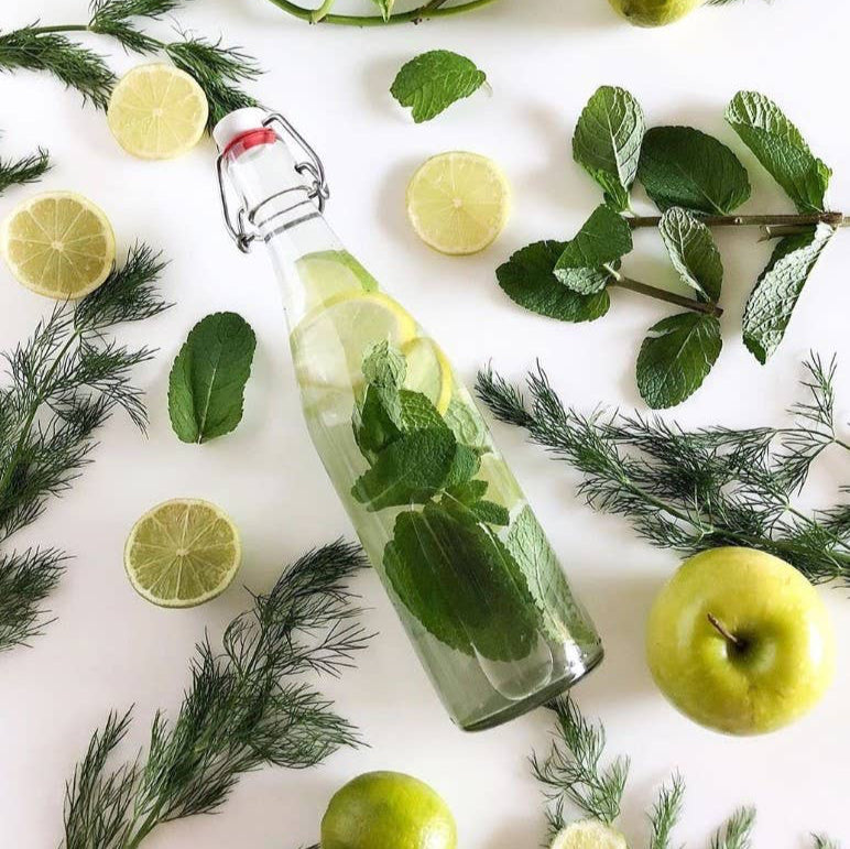 A le parfait glass bottle surrounded by mint and greenery