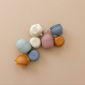 Colorful silicone teether toys on a beige background