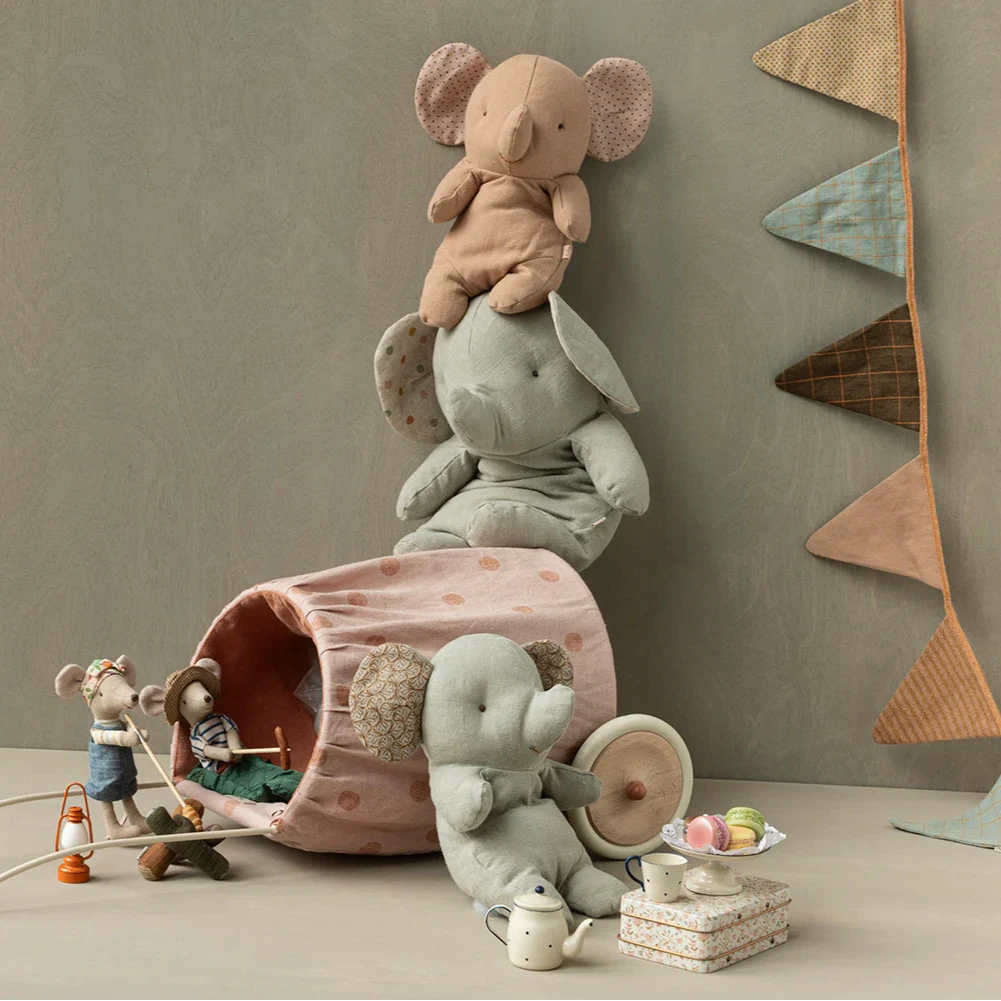 A toy mouse dressed in a brown and green outfit with a hat, resembling a hiker, made of cotton and recycled polyester.