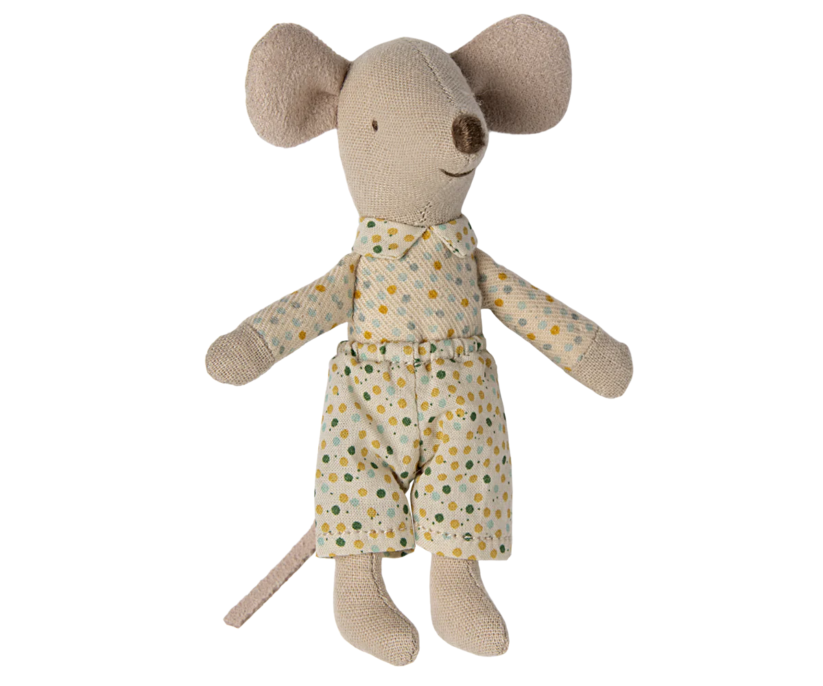 Stuffed toy mouse wearing a polka dot outfit on a white background