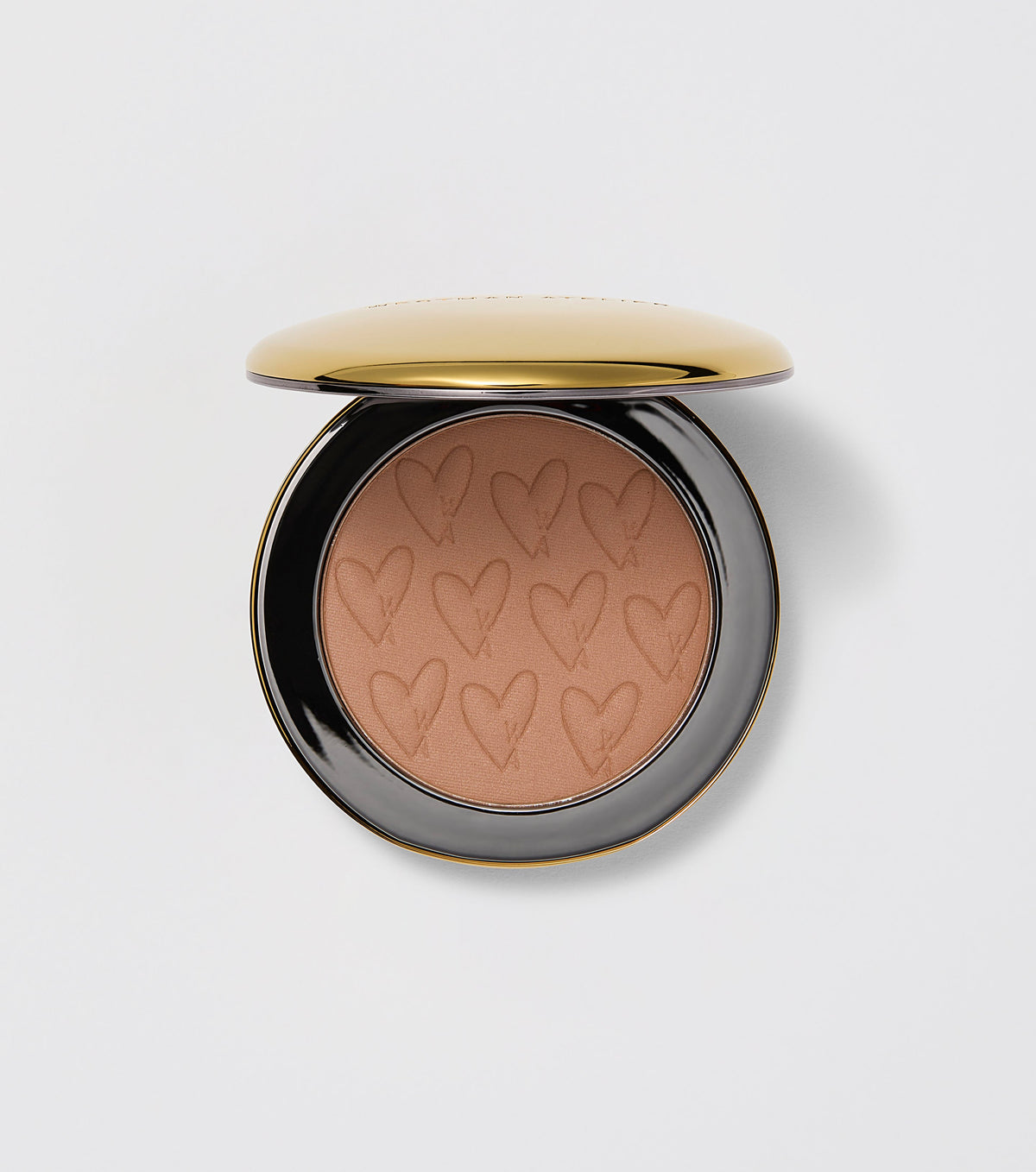 A compact pan of Westman Atelier Beauty Butter Powder Bronzer with a matte finish and heart patterns on the surface.