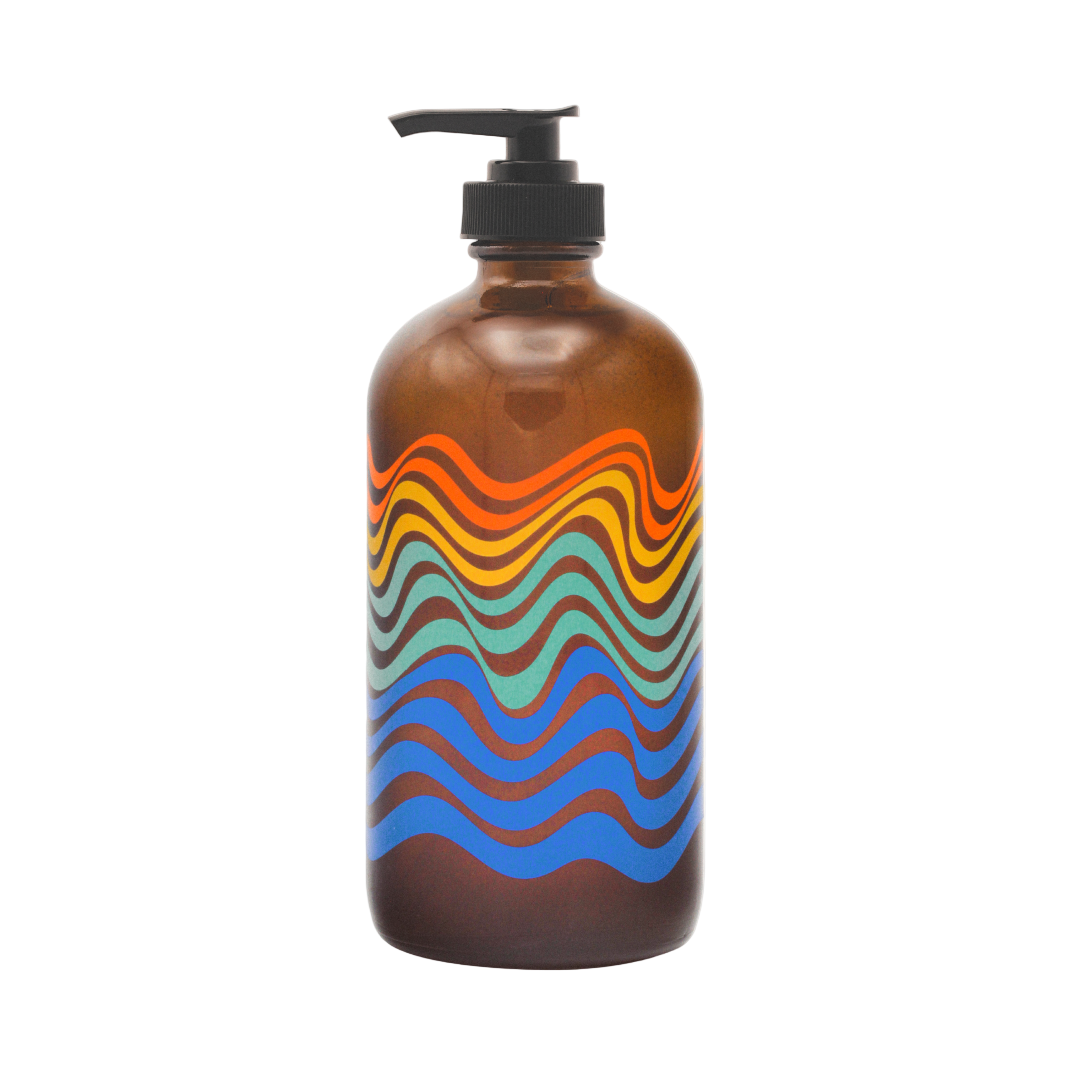 Brown bottle with colorful wavy pattern and black pump on a white background