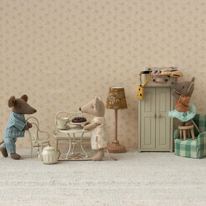 Miniature scene with toy mice in a living room setting.