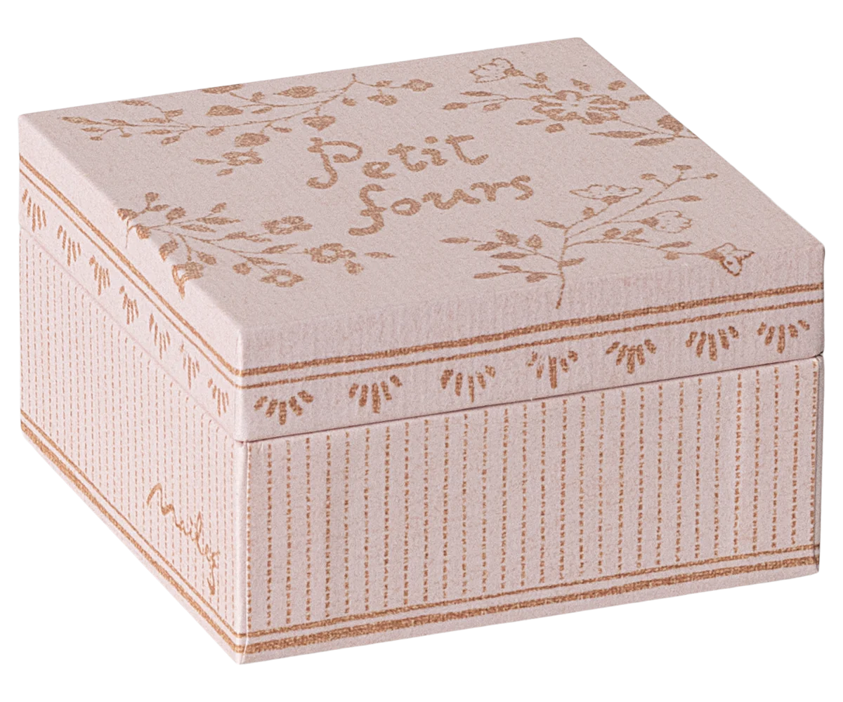 Decorative box with floral patterns and 'Petit fours' text on a white background