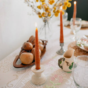 A pair of carrot taper candles, made by Happy Organics in California