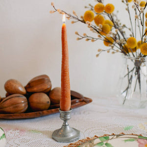 A carrot taper candle, made by Happy Organics in California
