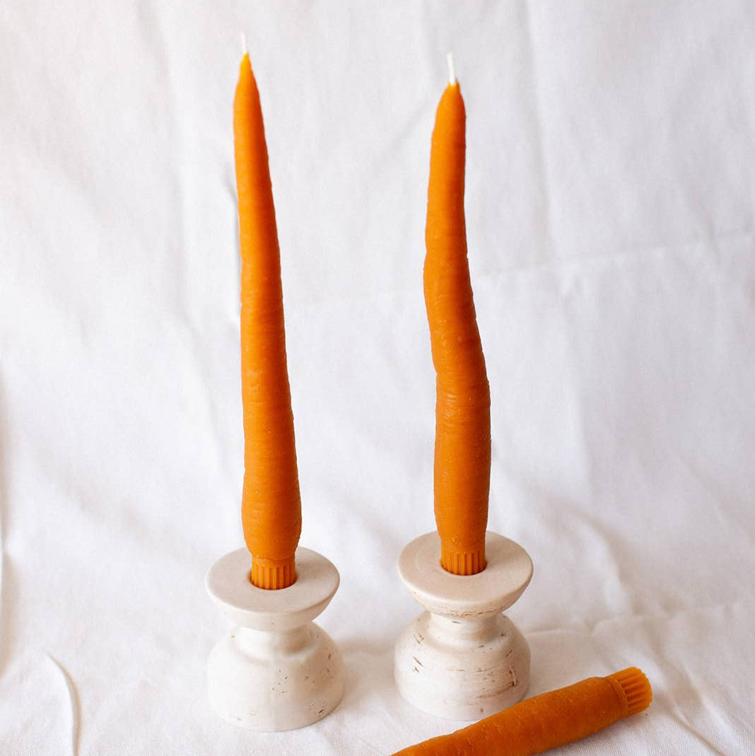 A pair of carrot taper candles, made by Happy Organics in California