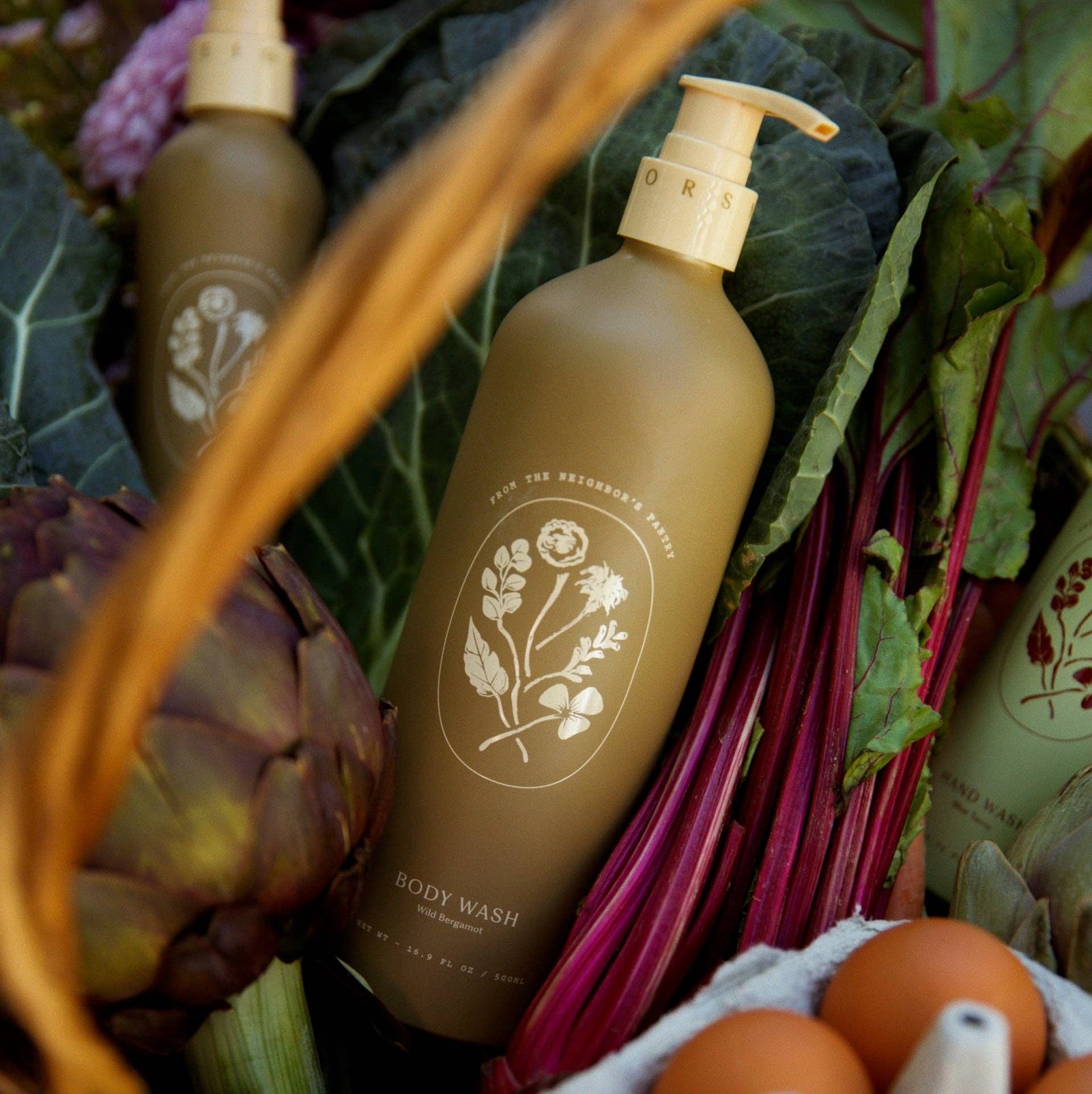 Brown body wash bottle with floral design on a blurred natural background