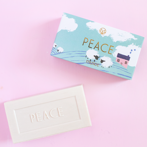 Bar of soap with 'PEACE' text on a pink background