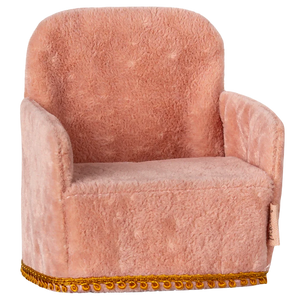 A small, rose-colored folding chair with a gold-colored metal frame, designed for small toy figures.