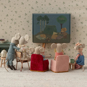 Miniature scene of mice watching a picnic-themed picture on a screen.