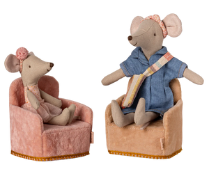 Two toy mice sitting on chairs with a white background