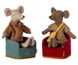 Two plush mouse toys sitting on chairs, one with a guitar and the other in a coat.
