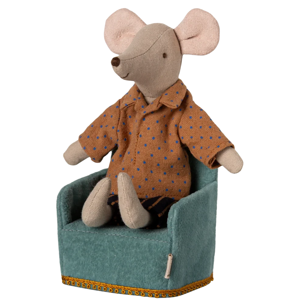 Stuffed mouse toy wearing an orange shirt sitting on a green chair with a white background