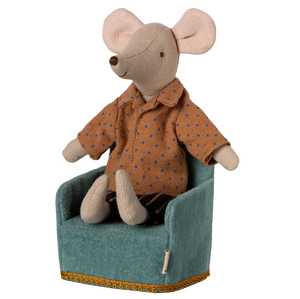 Stuffed mouse toy wearing an orange shirt sitting on a green chair with a white background