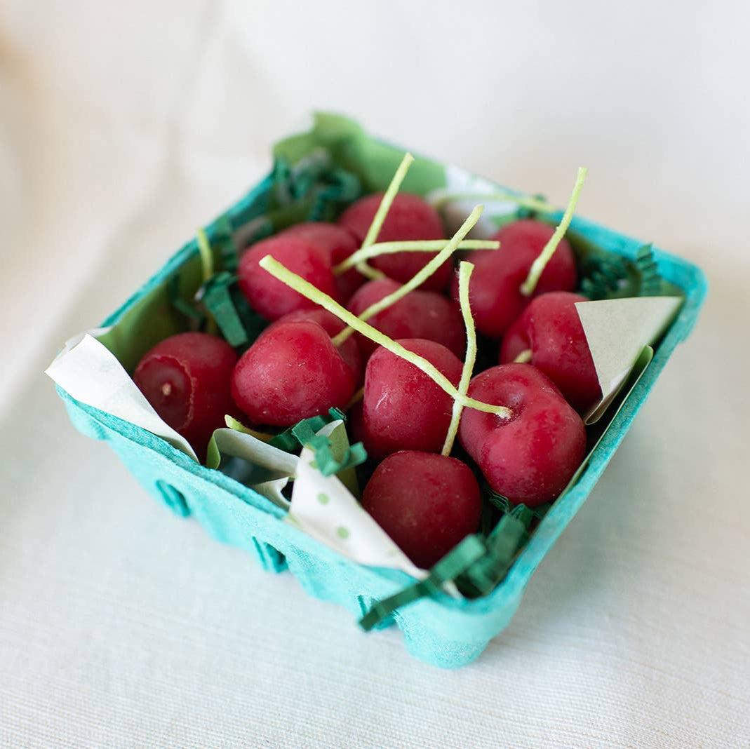 A box of organic beeswax cherry candles, made by hand in California by Happy Organics