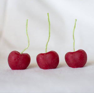 A group of three organic beeswax cherry candles, made by hand in California by Happy Organics