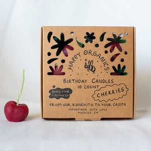 A box of organic cherry candles, made in California by Happy Organics