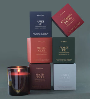 Collection of Botanica candles and boxes on a gray background