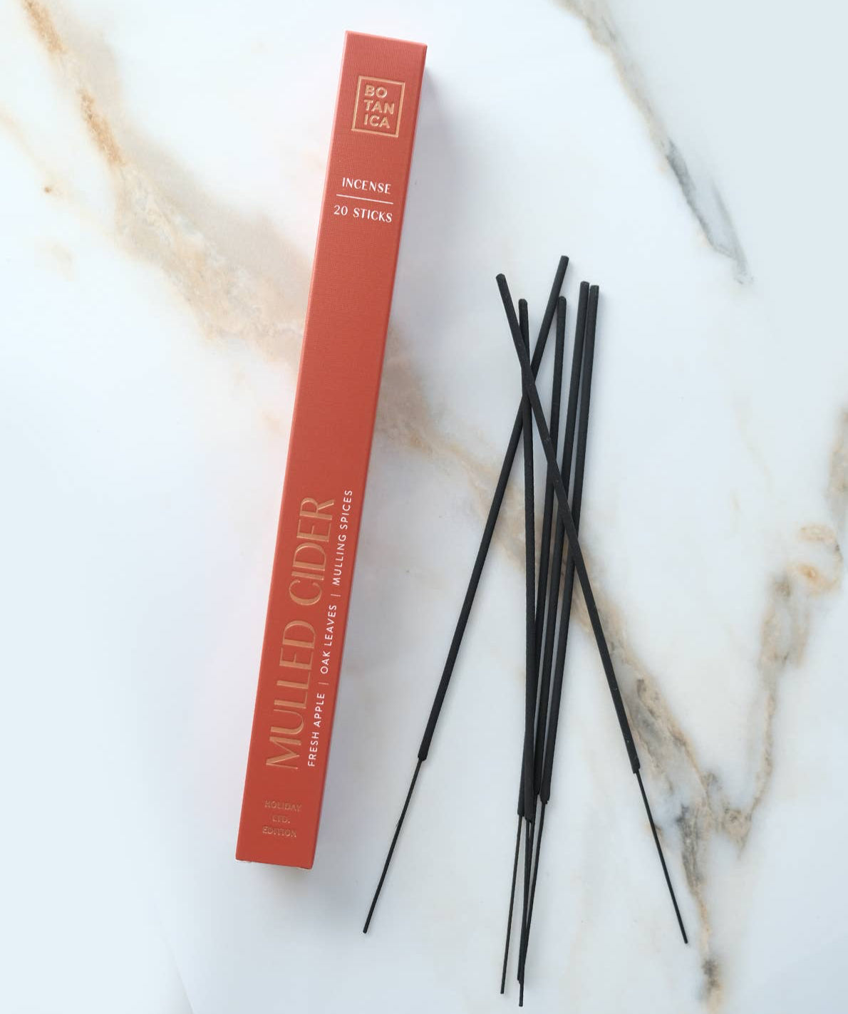 Red box of incense sticks labeled 'Mulled Cider' on a marble surface