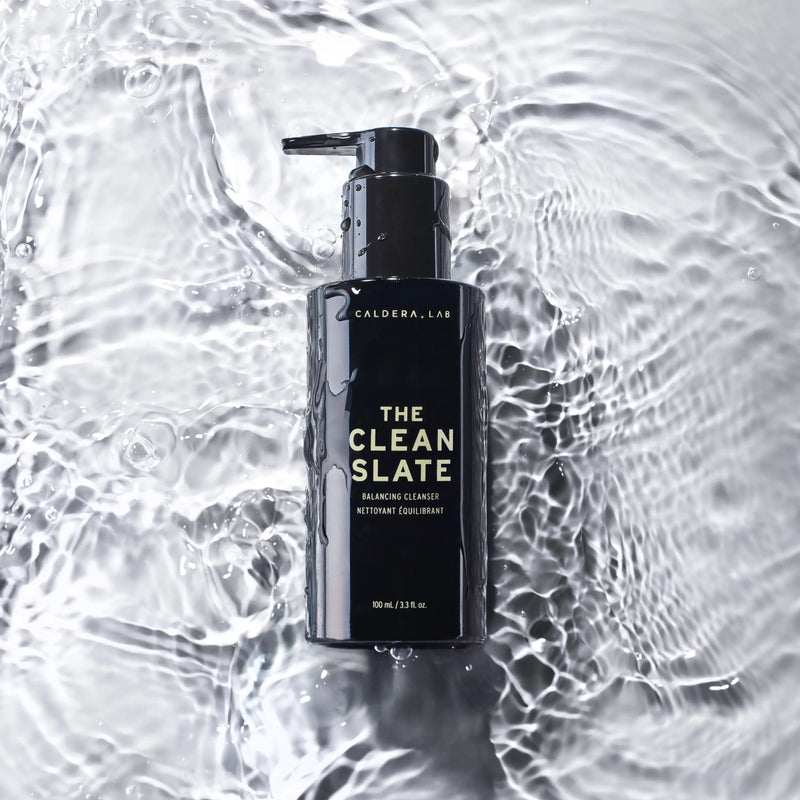 A black pump bottle labeled 'the clean slate' from Caldera + Lab, classified as a 'Night Cleaner' on the packaging.