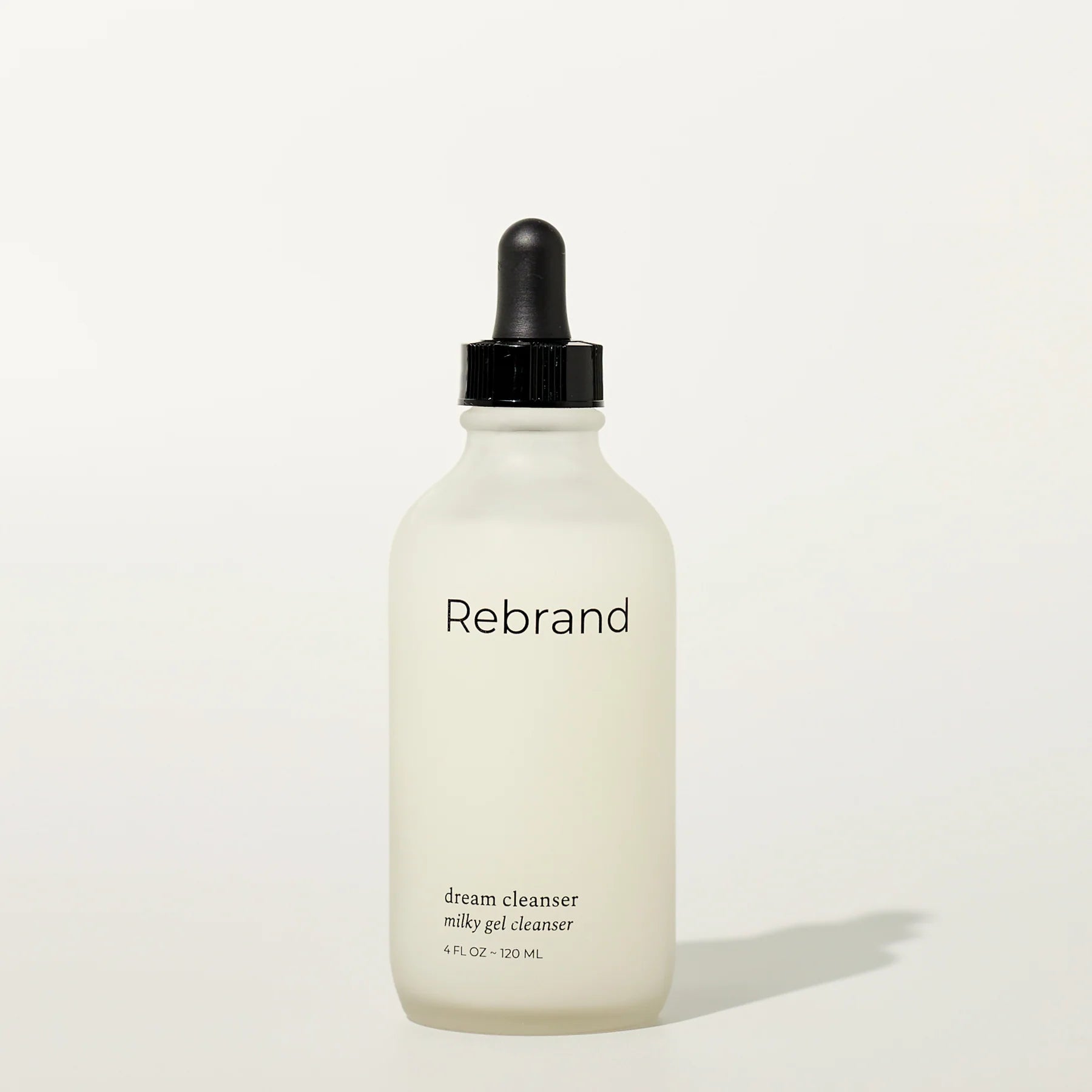 Bottle of Rebrand dream cleanser on a white background