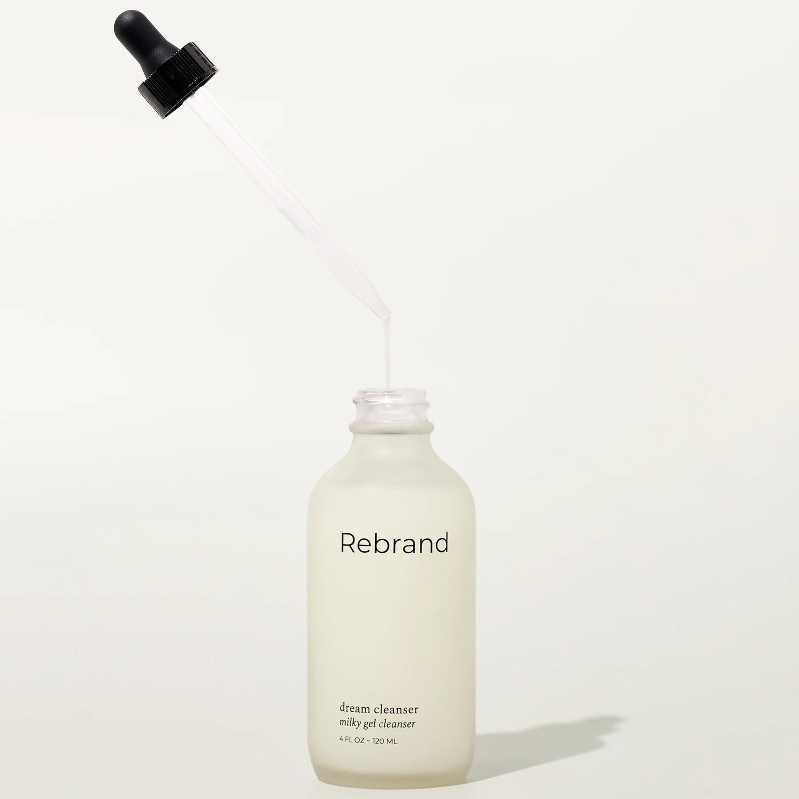 Bottle of Rebrand dream cleanser on a white background
