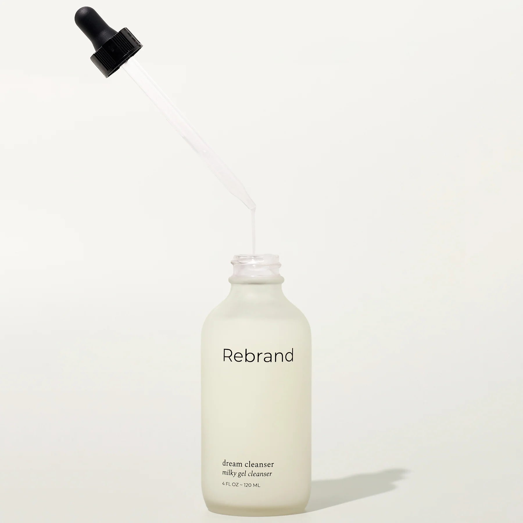 Bottle of Rebrand dream cleanser on a white background