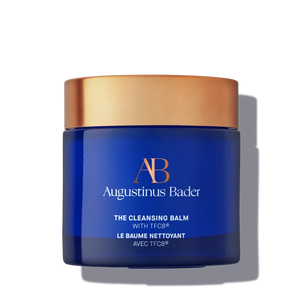 A blue jar with a copper lid. It says "The Cleansing Balm" in white text