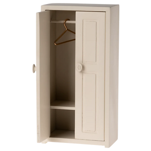 Beige cabinet with a hanger inside on a white background