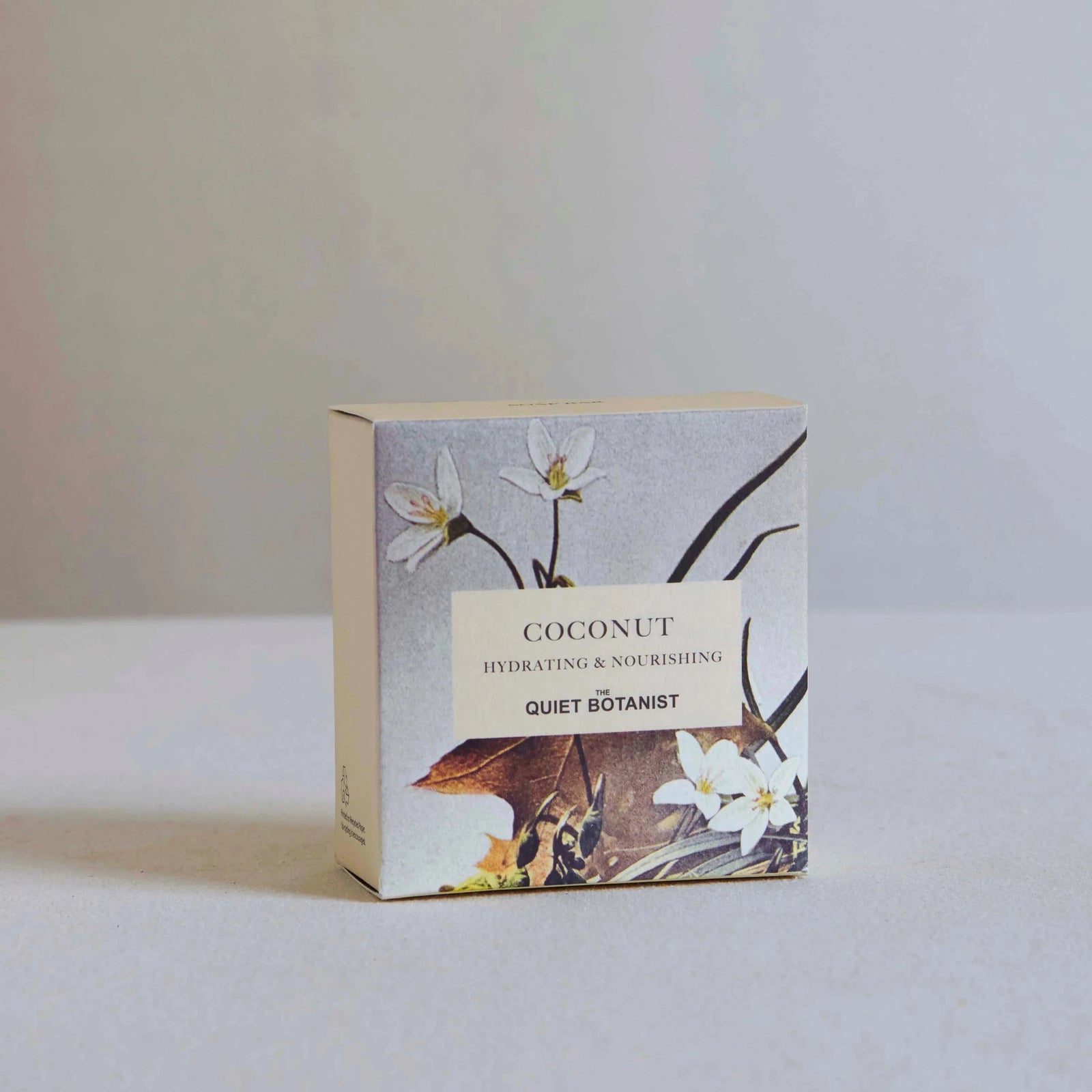 Box of coconut soap with floral design on a light background