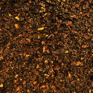 Close-up of dark tea leaves with small particles