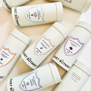 Collection of 'Quiet Botanist' skincare products on a light background